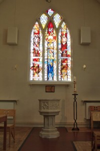 The magnificent stained-glass window and Font